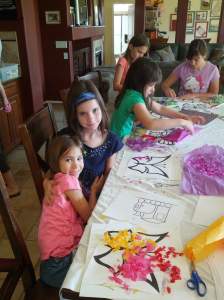 My girls at a friend's house, doing crafts. Fiala has the blue headband, and Audrey is in the background, top left.